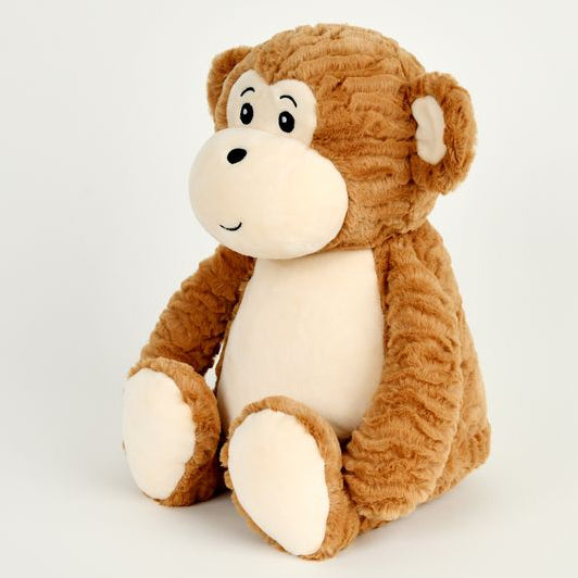 A plush toy monkey sitting upright on a clean white background. The monkey has a textured brown body, a cream-colored face and belly, and black embroidered eyes and nose.