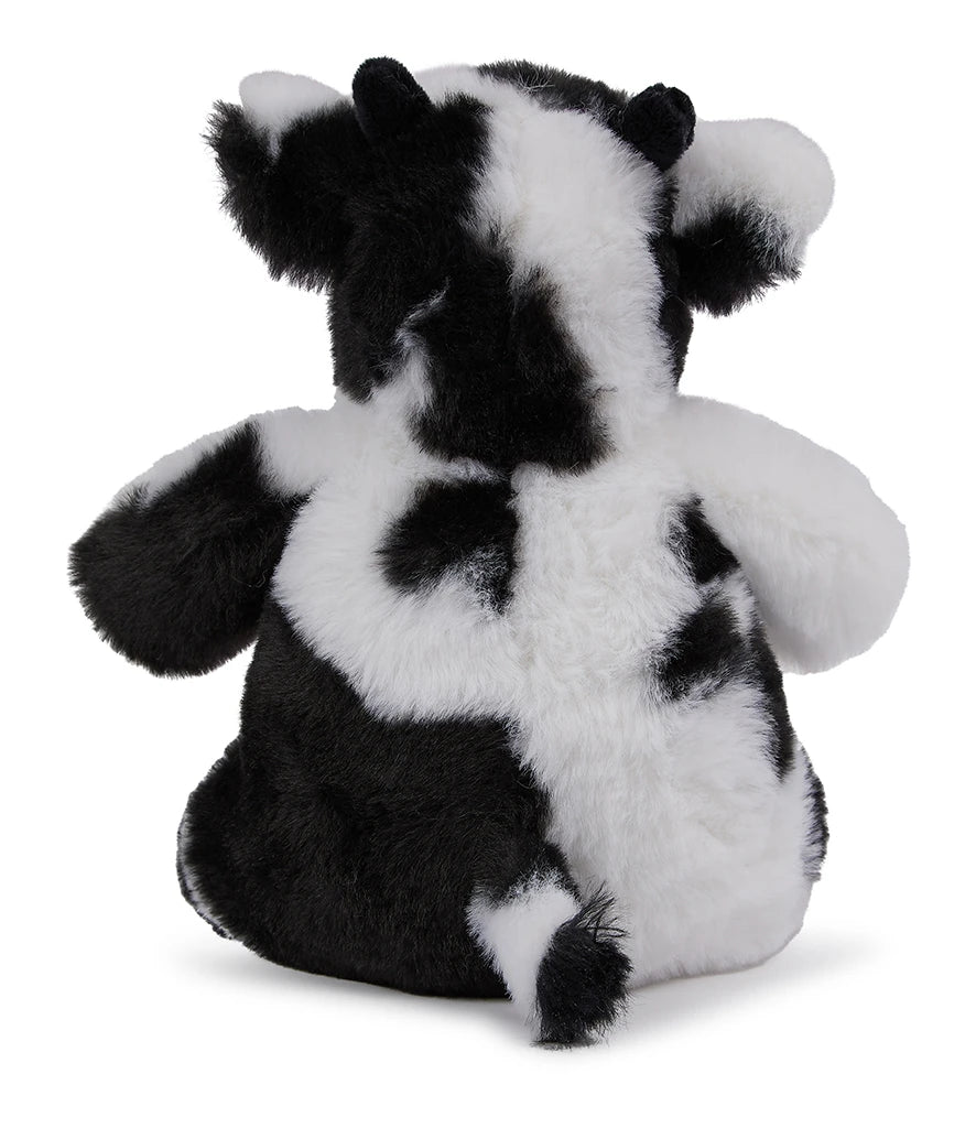 Black and white cow plush toy on a white background