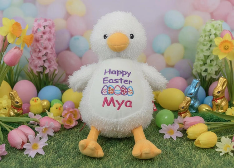 Plush duck with 'Happy Easter Mya' text surrounded by Easter decorations.