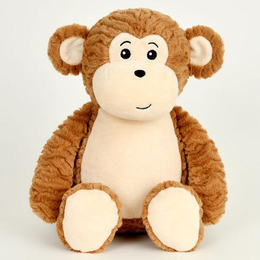 A plush toy monkey sitting upright against a plain light gray background. The monkey has medium brown textured fur on its head, arms, and legs, with a cream-colored face, inner ears, and feet, and simple black embroidered facial features.