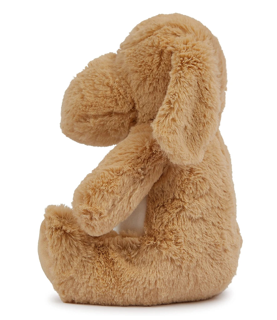 Plush dog toy in a sitting position on a white background