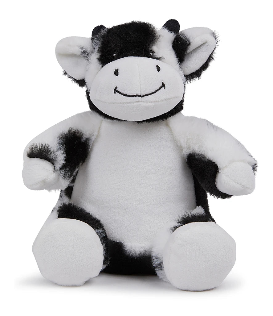 Black and white plush cow toy on a white background