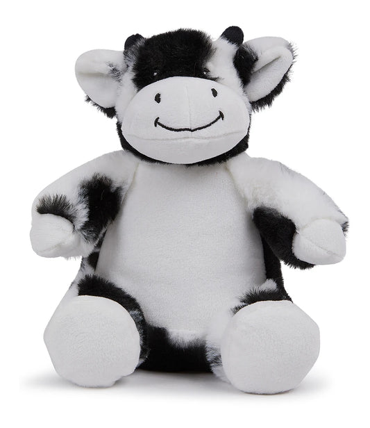 Black and white plush cow toy on a white background