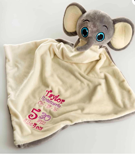 Plush elephant toy on a personalized blanket with text
