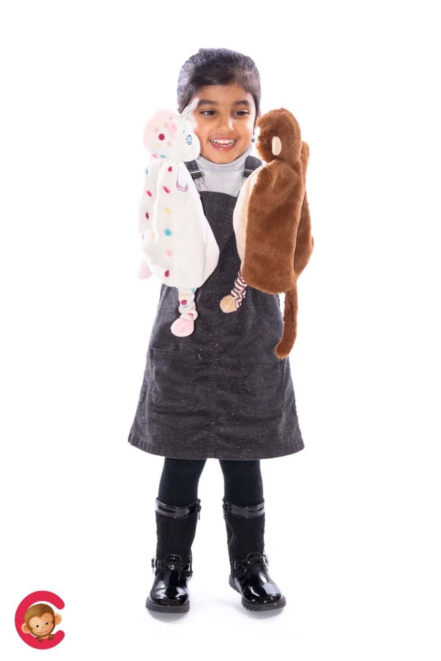 Child holding two stuffed animals against a white background