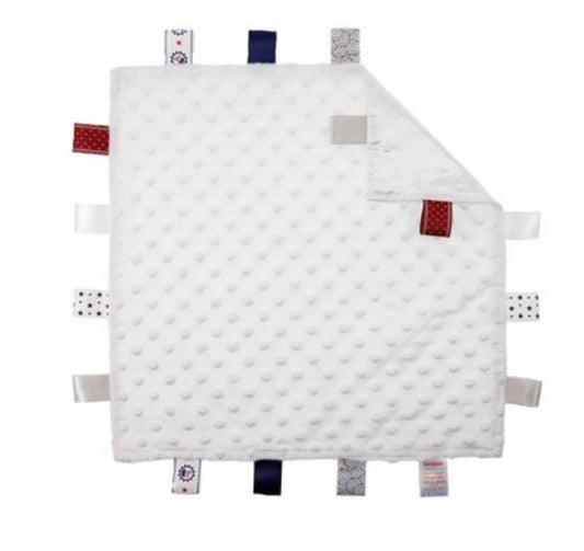 White quilted baby blanket with colorful tabs on a white background