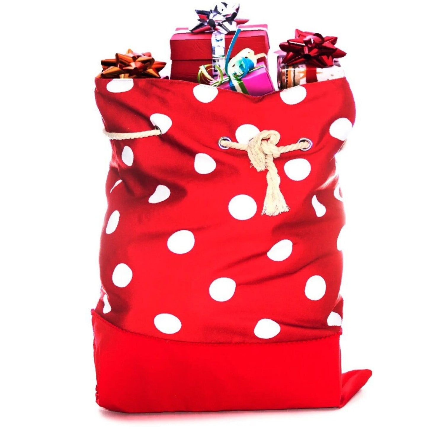 Red polka dot gift bag filled with wrapped gifts on a white background