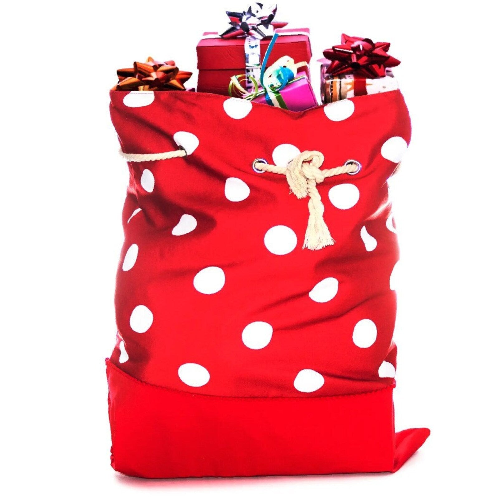 Red polka dot gift bag filled with wrapped gifts on a white background