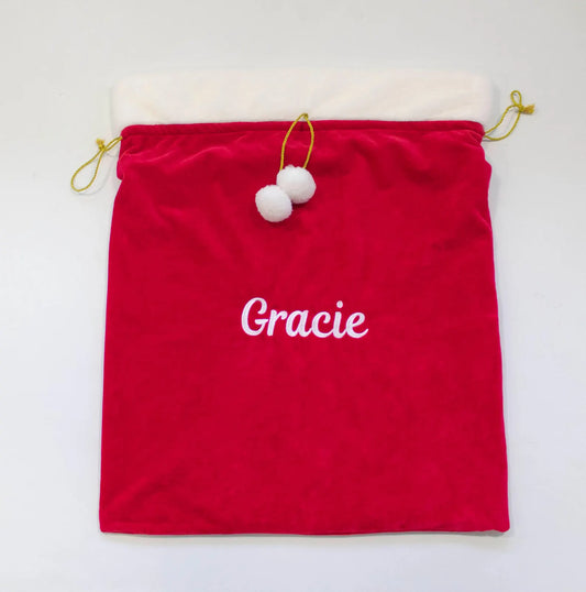 Red drawstring bag with 'Gracie' embroidered on it, on a white background