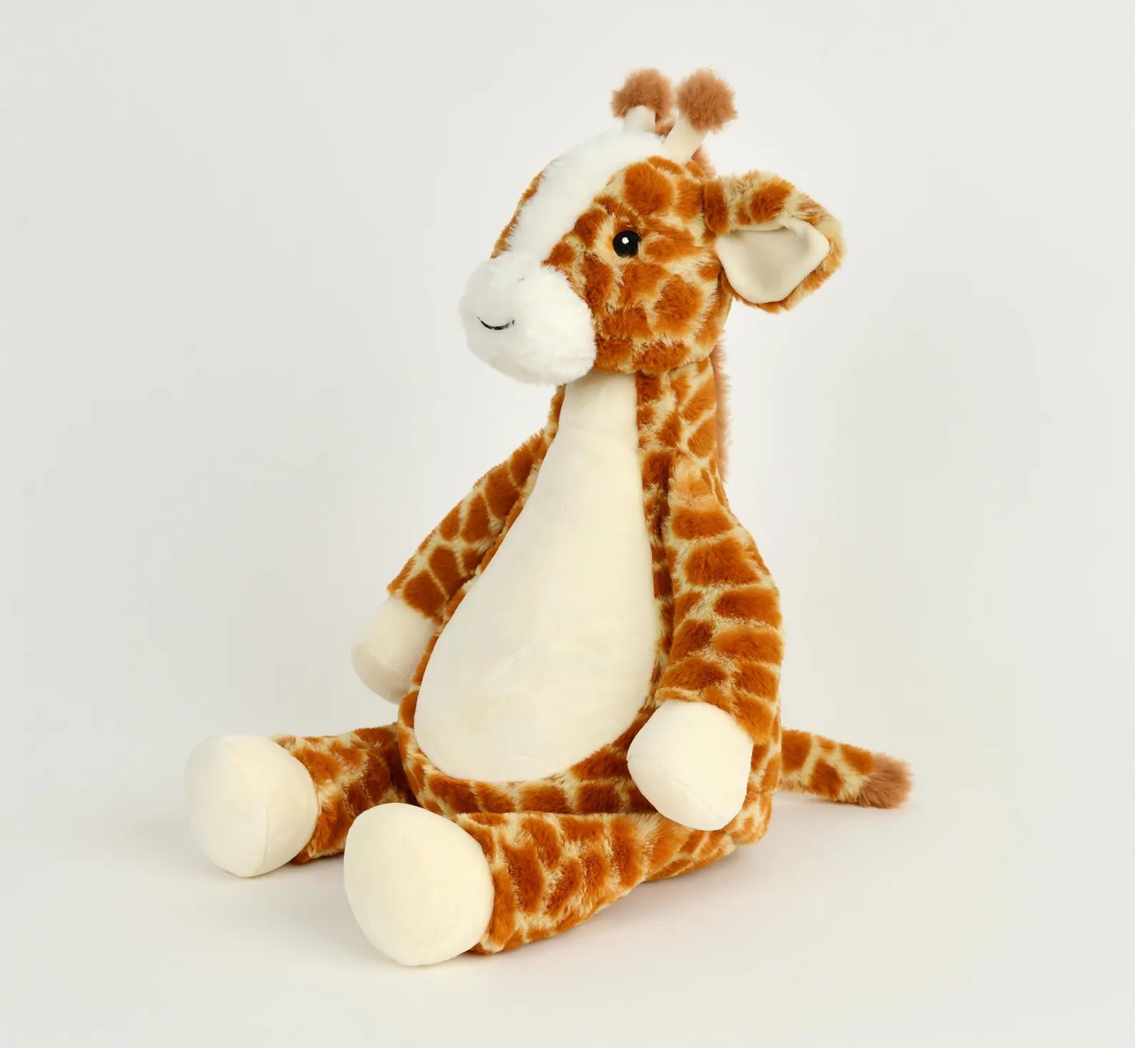 Plush giraffe toy on a white background