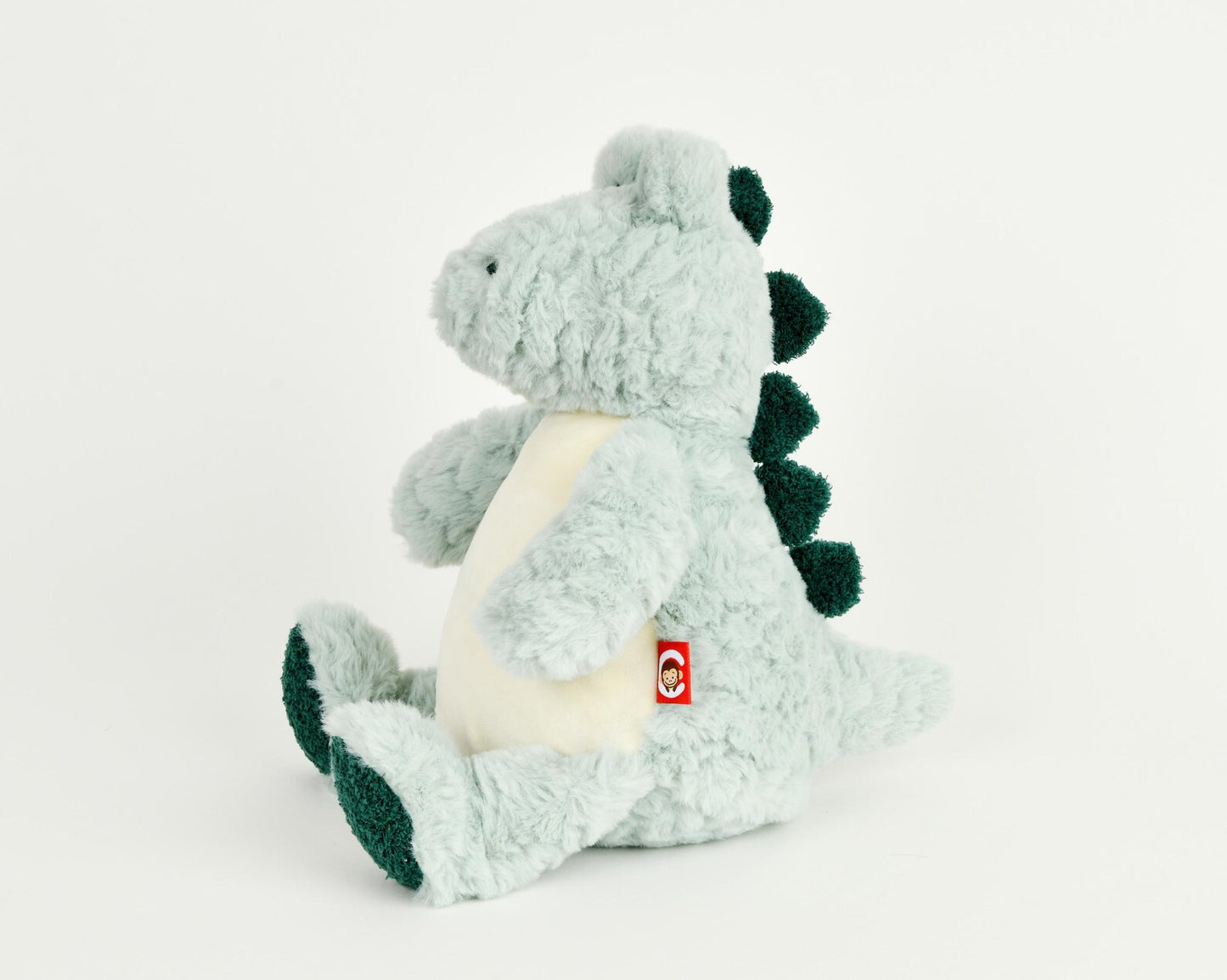 Plush alligator/crocodile toy with a red tag on a white background