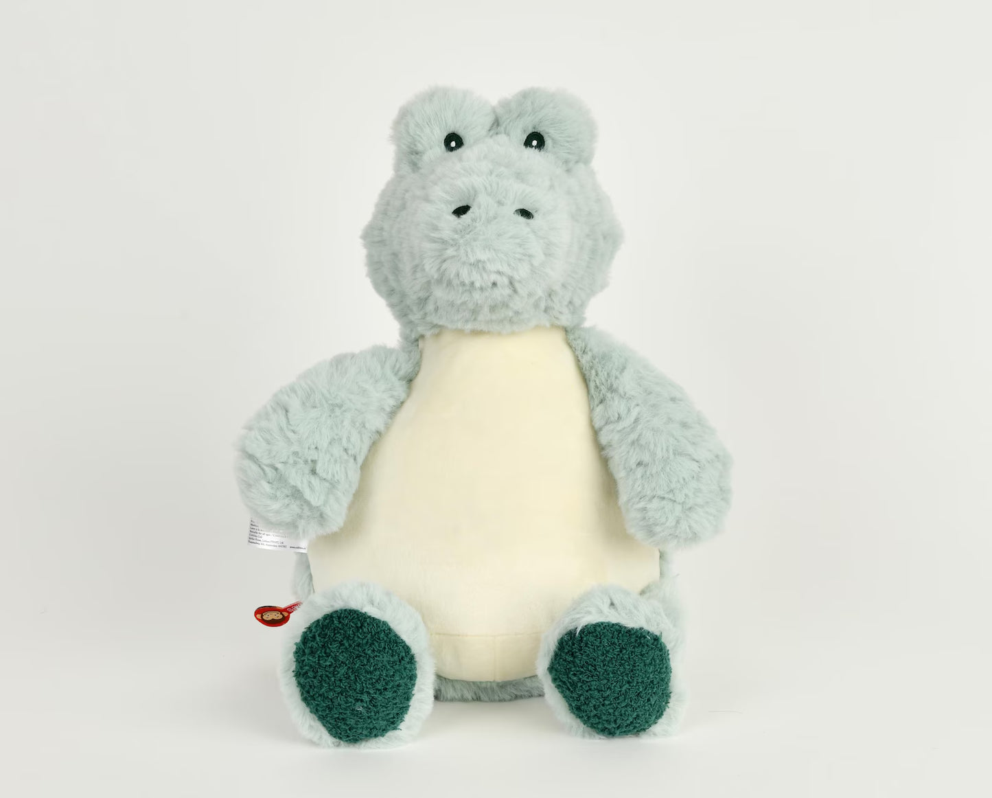 Plush toy alligator/crocodile with a white belly on a light gray background