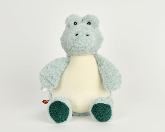 Plush toy alligator/crocodile with a white belly on a light gray background