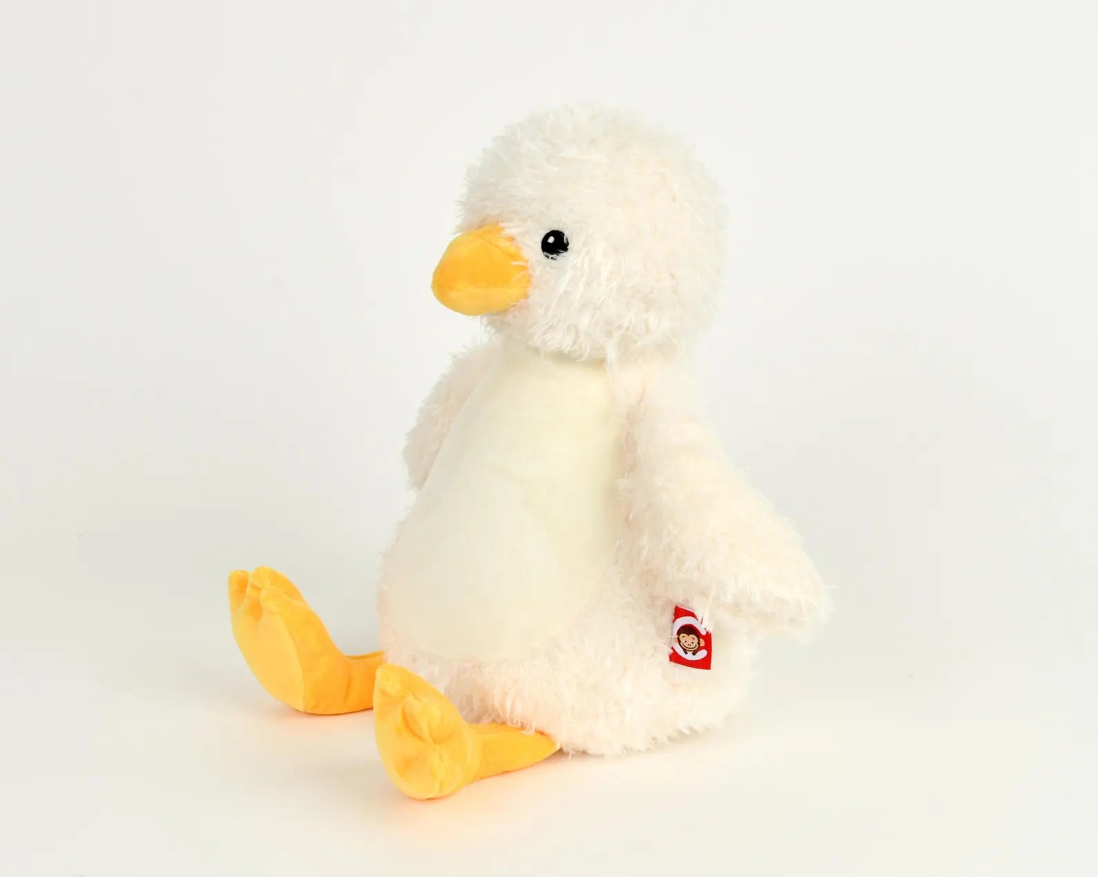 Plush toy penguin on a light gray background