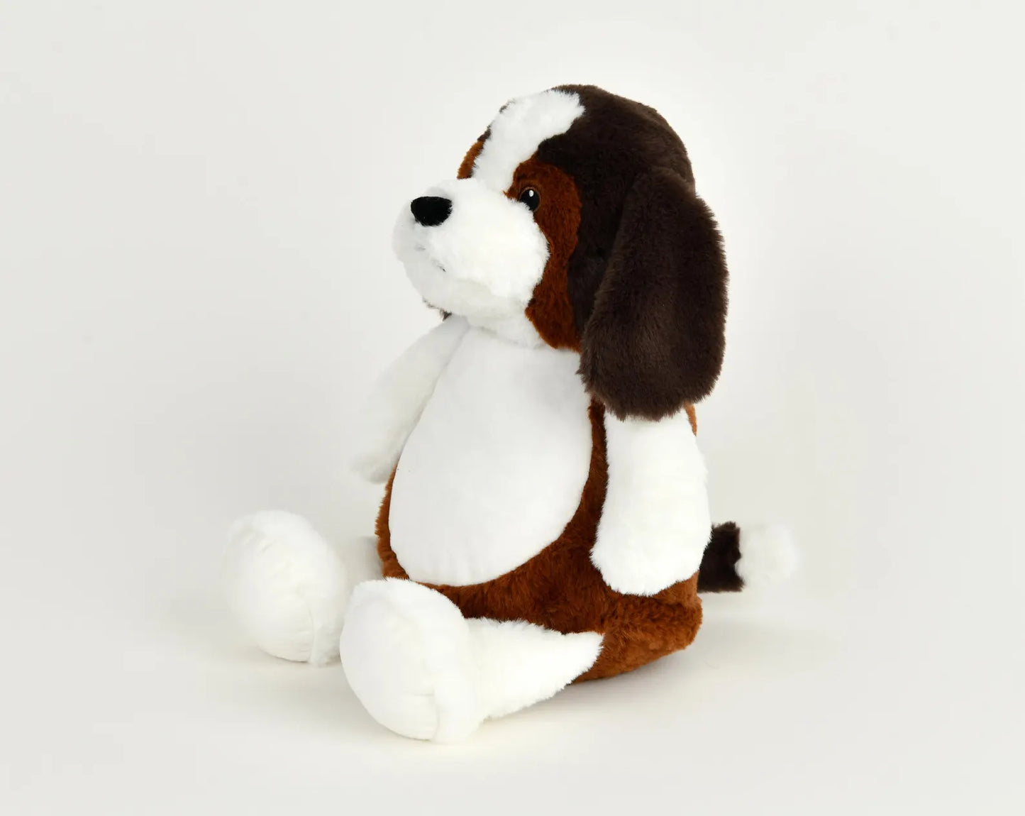 Plush dog toy with brown and white color pattern on a light gray background