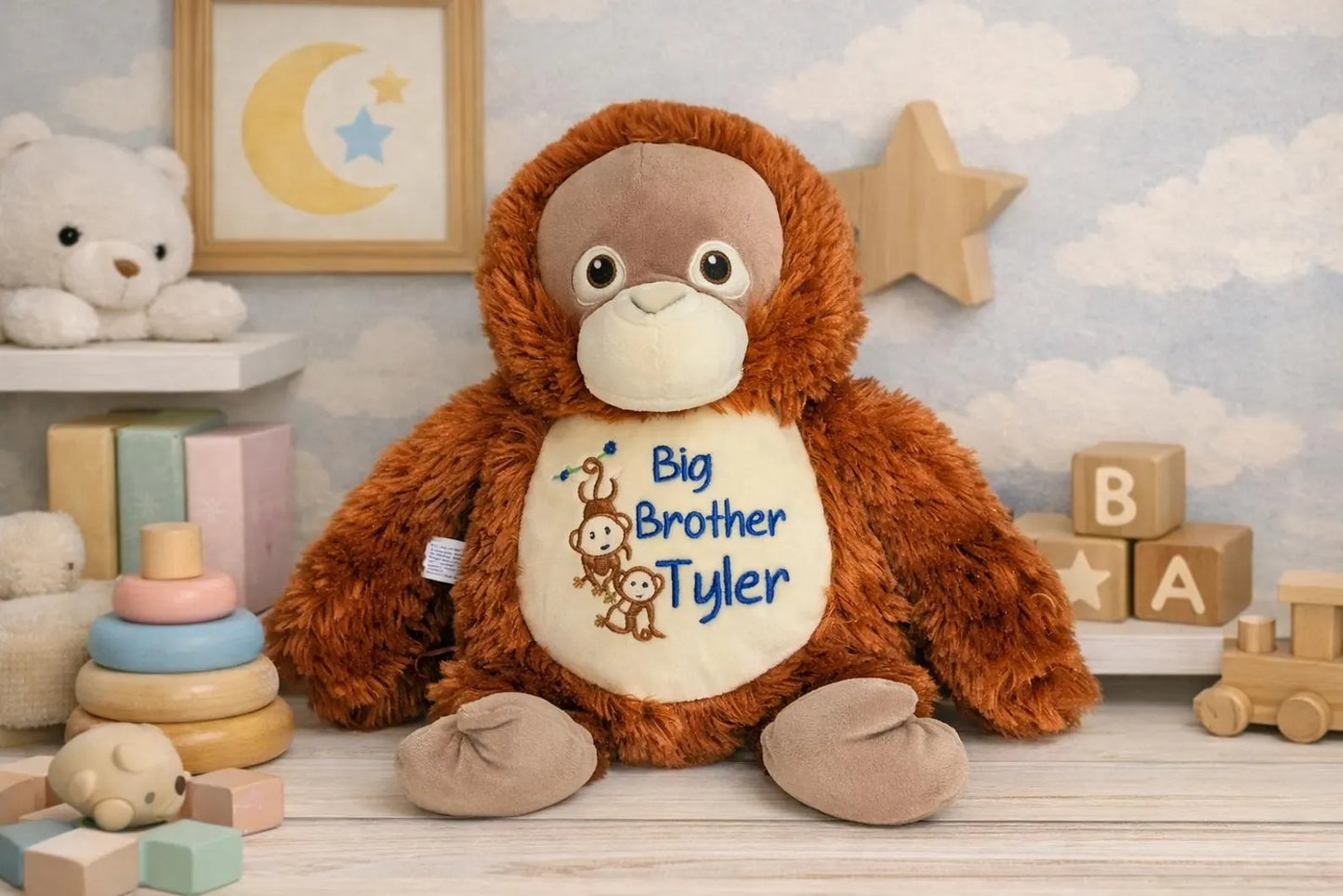 Plush monkey toy with 'Big Brother Tyler' text in a nursery setting