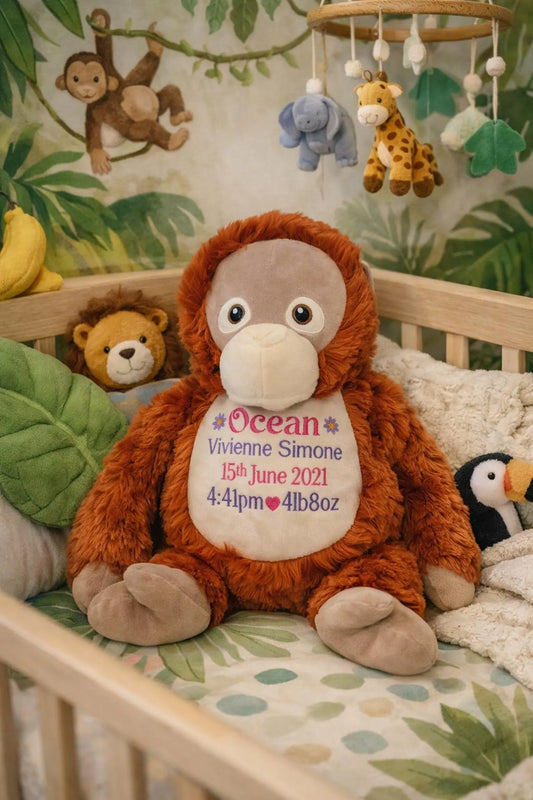 Stuffed monkey toy with personalized details in a crib with jungle-themed decorations