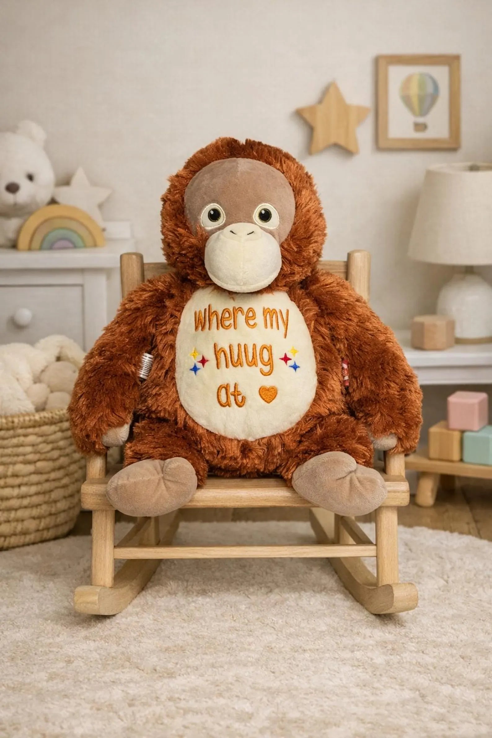Plush monkey toy with a message on a wooden chair in a nursery setting