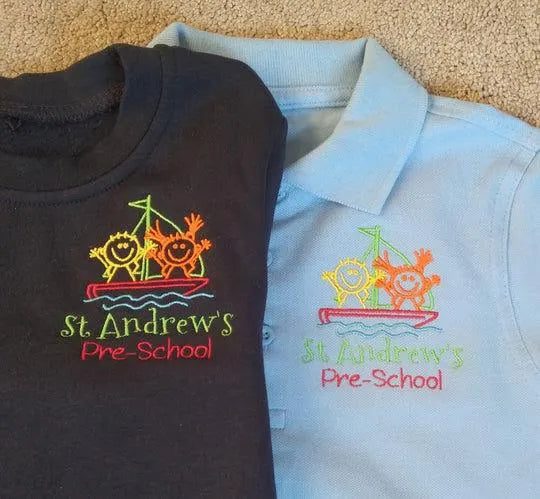 Black t-shirt and light blue polo shirt with 'St. Andrew's Pre-School' logo on a beige carpet.