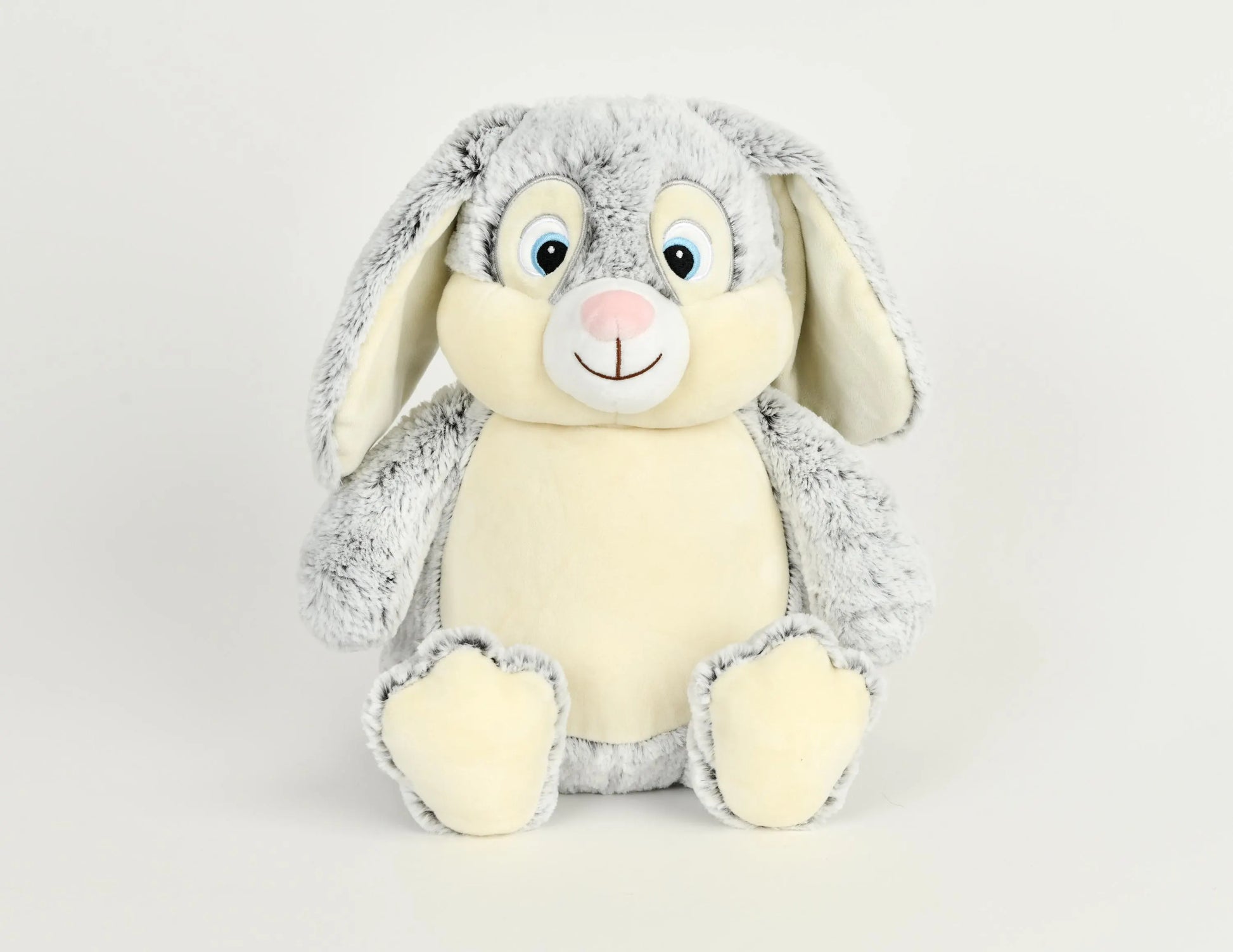 Plush toy rabbit with gray fur on a light gray background