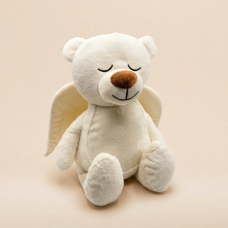 Plush teddy bear with angel wings on a beige background